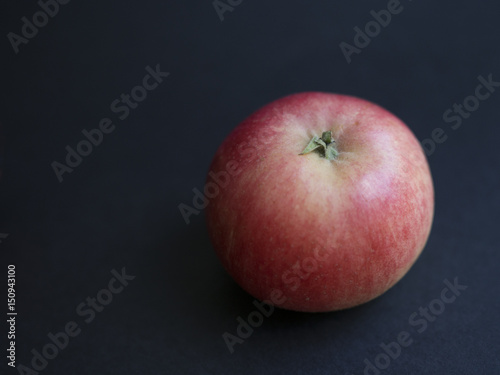 Fresh Danish autumn apple (Discovery) isolated on black background