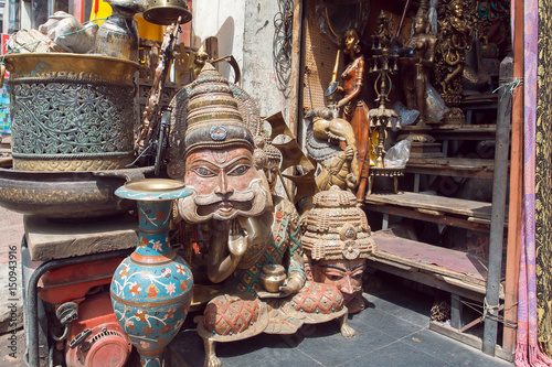 Traditional indian masks in store with vintage furniture, art and antiques