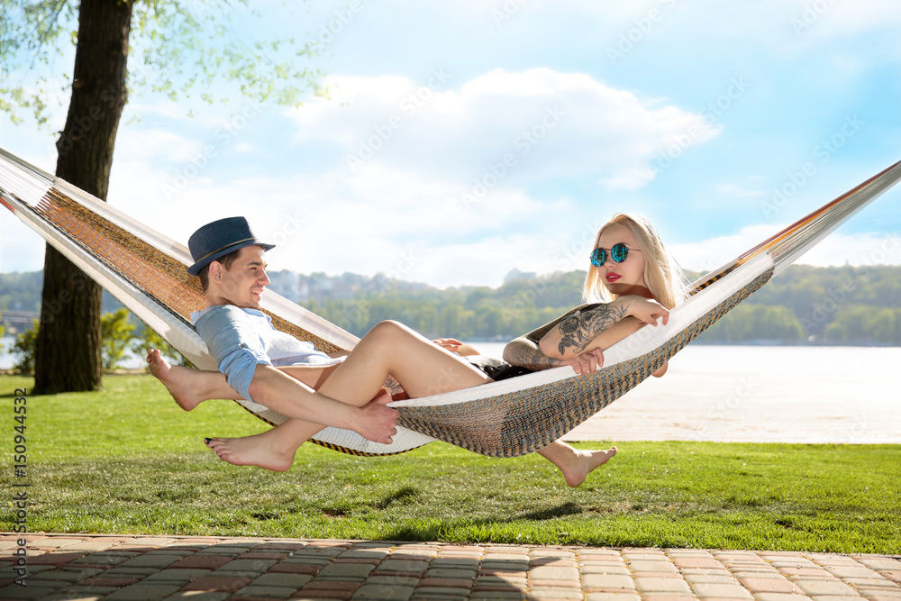 Naklejka premium Contented couple relaxing in a hammock