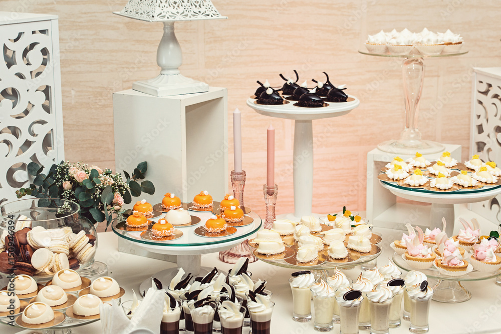 modern stylish luxury wedding candy bar. a wide range of sweets on a wedding cande bar.