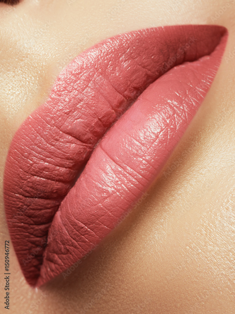 Fototapeta premium Close-up beautiful female lips with bright lipgloss makeup. Perfect clean skin, light fresh lip make-up