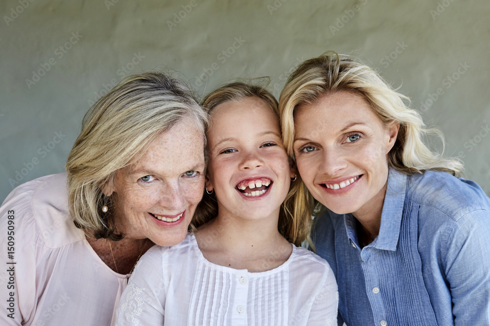 Family picture of little girl with mother and grandmother head to head Family picture of little girl with mother and grandmother head to head