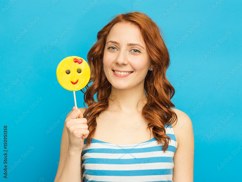 Young foxy beautiful woman with citrus on blue background. Long hair Young foxy beautiful woman with citrus on blue background. Long hair