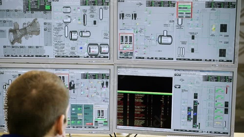 The operator of a thermal power plant sitting at the control console. HD