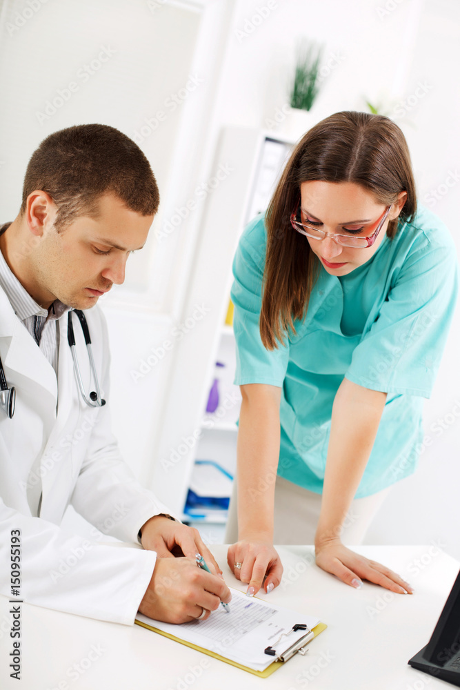 Doctor and nurse talking at the office.