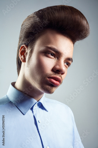 Side view of young man with retro classic pompadour hairstyle. studio shot.