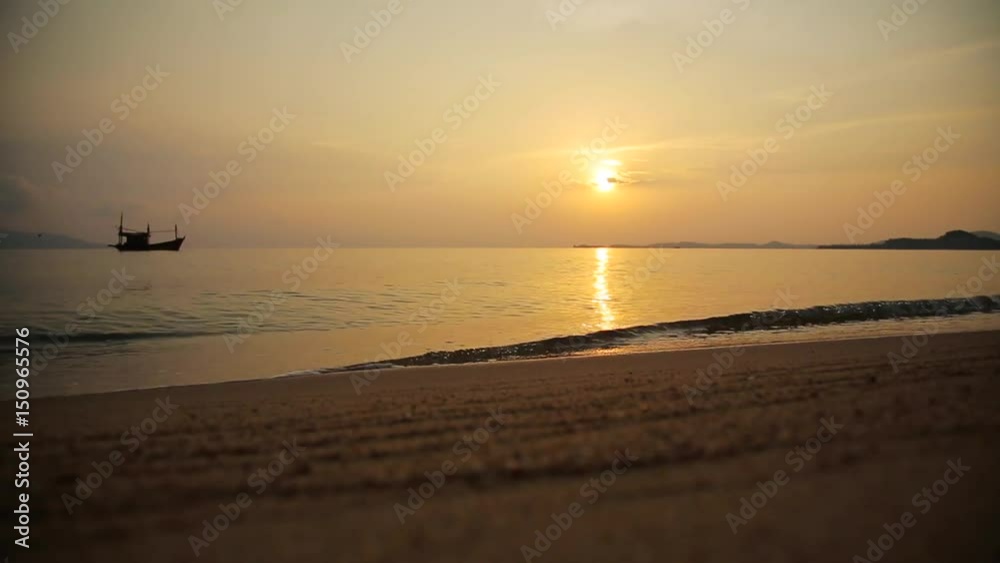 Sand and waves with boat on the beach with sunset Sand and waves with boat on the beach with sunset