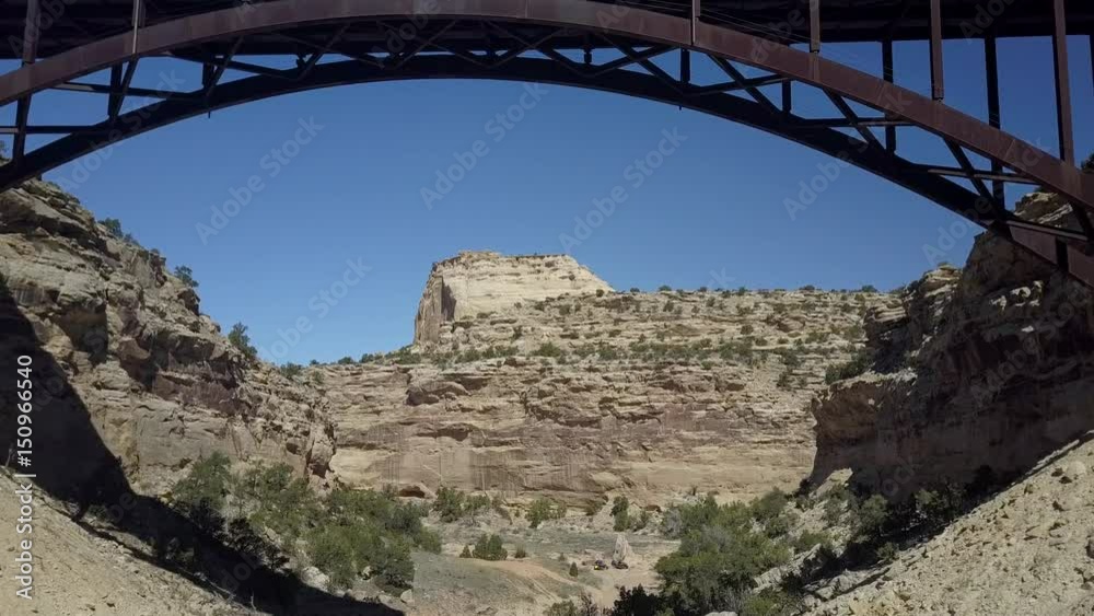 Aerial desert landscape Eagle Canyon Bridge Utah. Double span interstate I-70 highway crosses deep gorge. Travel traffic overhead drone view. San Rafael Reef. Wilderness desert environment.