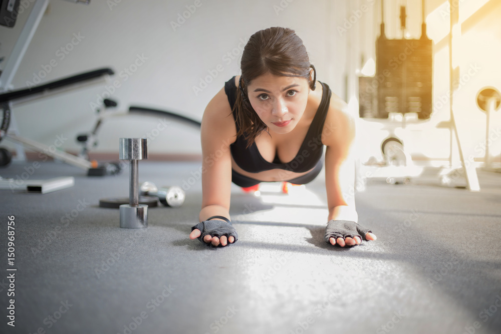 beautiful muscular fit woman exercising building muscles and fitness woman doing exercises in the gym. Fitness - concept of healthy lifestyle,soft focus beautiful muscular fit woman exercising building muscles and fitness woman doing exercises in the gym. Fitness - concept of healthy lifestyle,soft focus