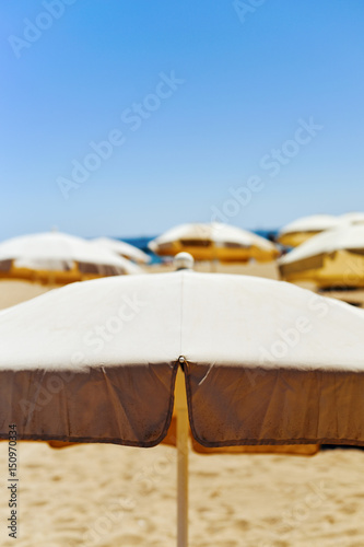 beige umbrellas in a quiet beach © nito