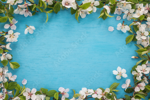   Spring flowers frame on wooden background 