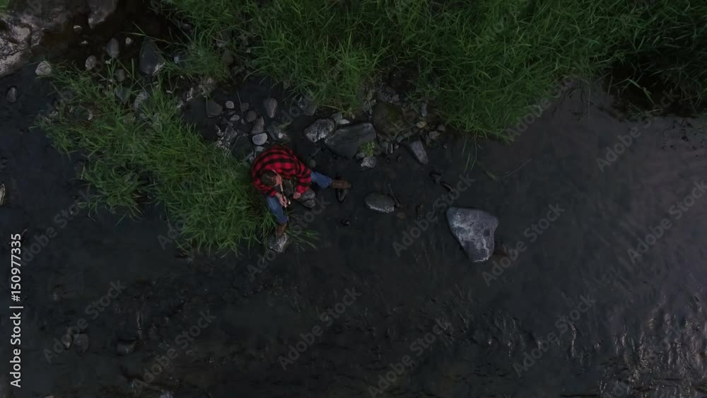 Aerial view of man fishing in creek in Oregon, USA Aerial view of man fishing in creek in Oregon, USA