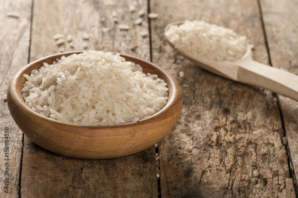 a bowl of rice on wooden surface a bowl of rice on wooden surface