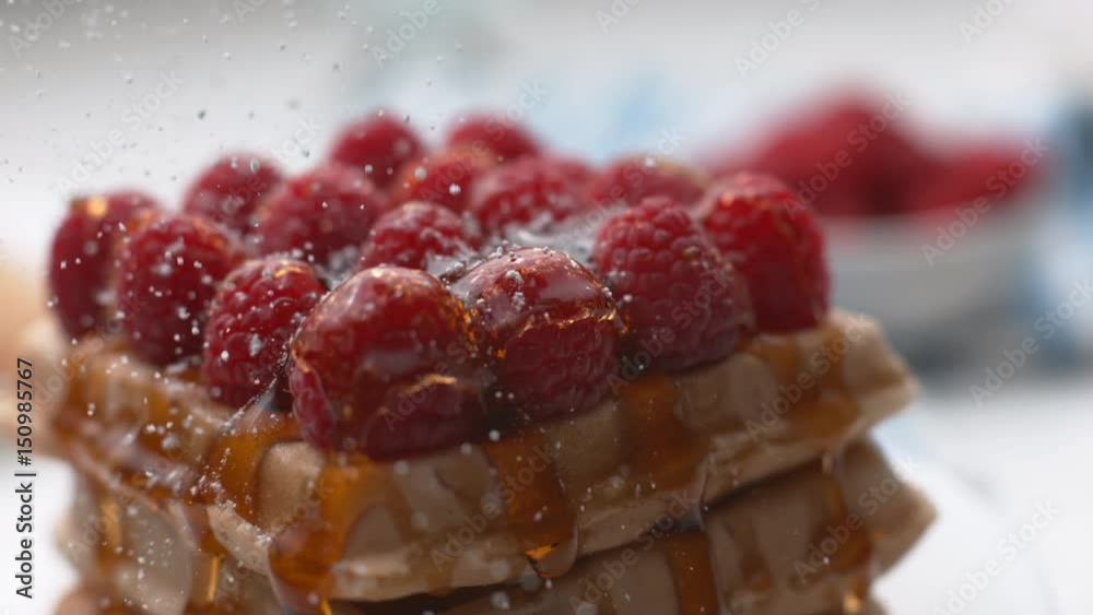 Powdered sugar sprinkled onto waffles with berries in super slow motion, shot on Phantom Flex 