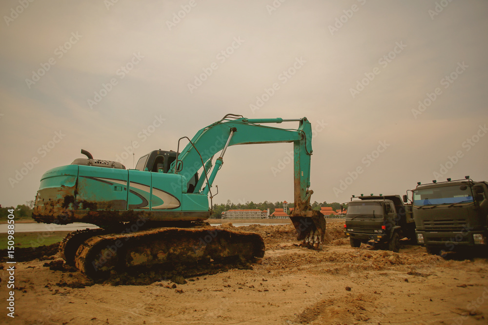 Obraz premium Excavator or backhoe at the construction site with Pale sky