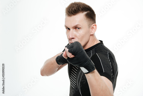 Handsome sportsman boxer standing isolated