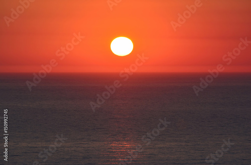 Sunset  red sky and dark sea surface