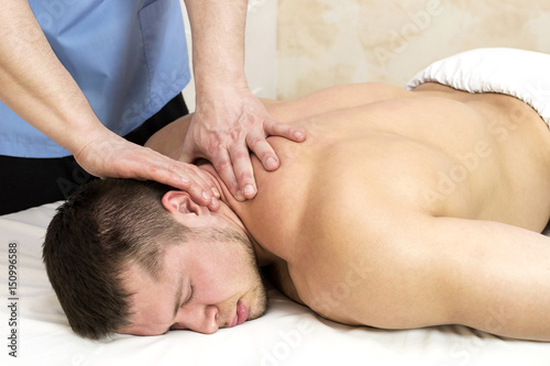 Young man on wellness treatments sports massage 