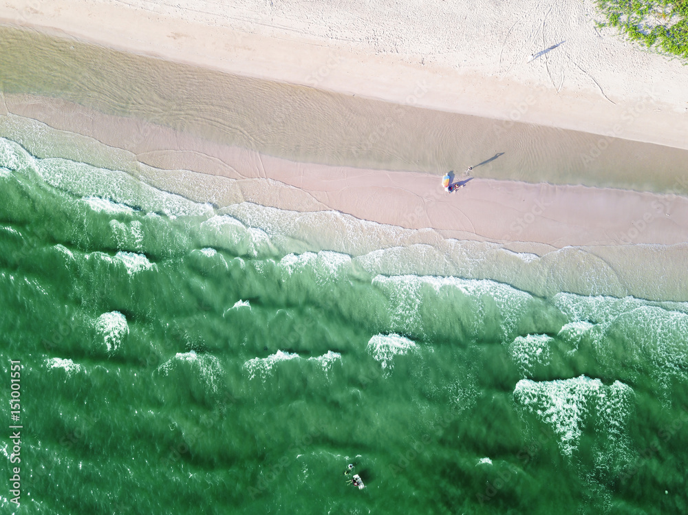 Sandy beach and greenish sea