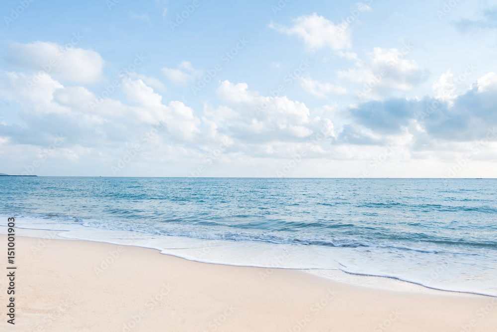 Beautiful white sand beach and ocean waves with clear blue sky background