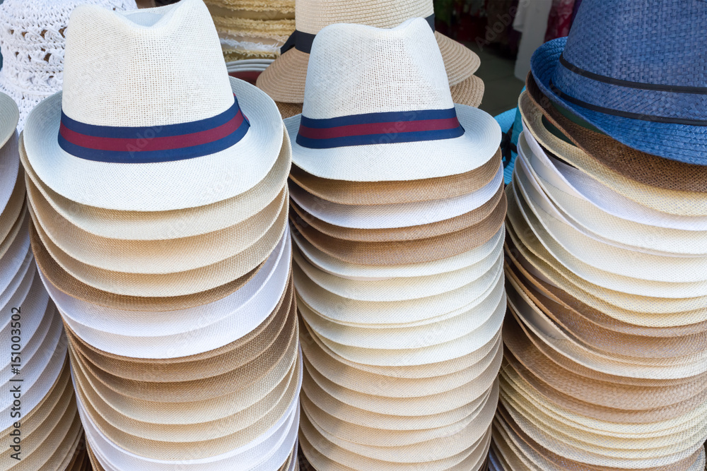 Stacks of men's hats on the street market 