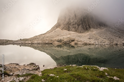 Lago alpino in una giornata nebbiosa nei pressi del gruppo sella, Val Gardena, Ortisei, Dolomiti,Italia photo