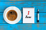 June 1st. Day of the month 1 , everyday calendar with morning coffee cup at blue wooden background. Summer concept, Top view