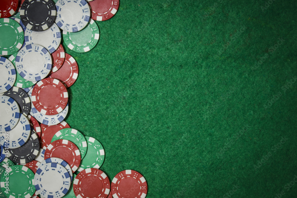 Background of poker chips on a green table