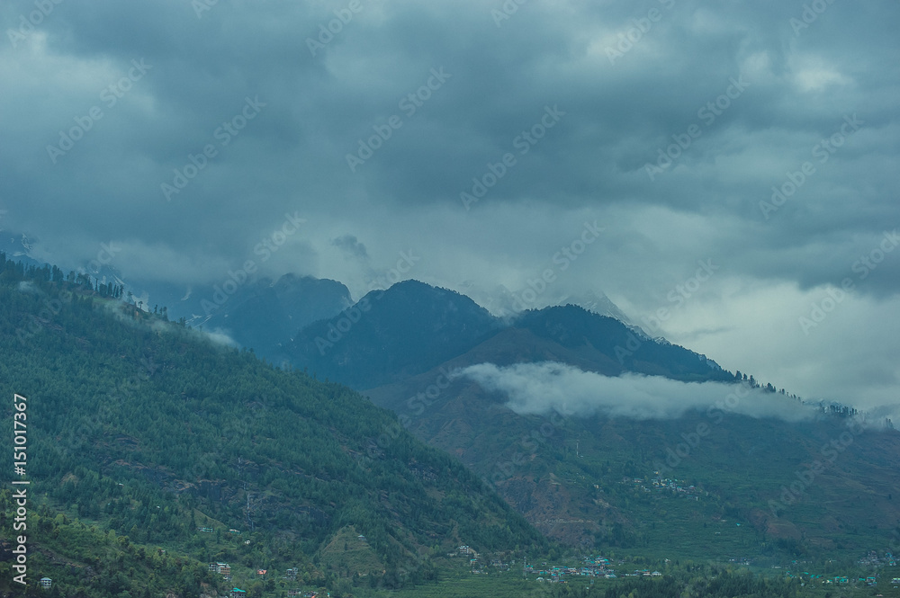 Gray clouds creeping through the Himalayan mountains Gray clouds creeping through the Himalayan mountains
