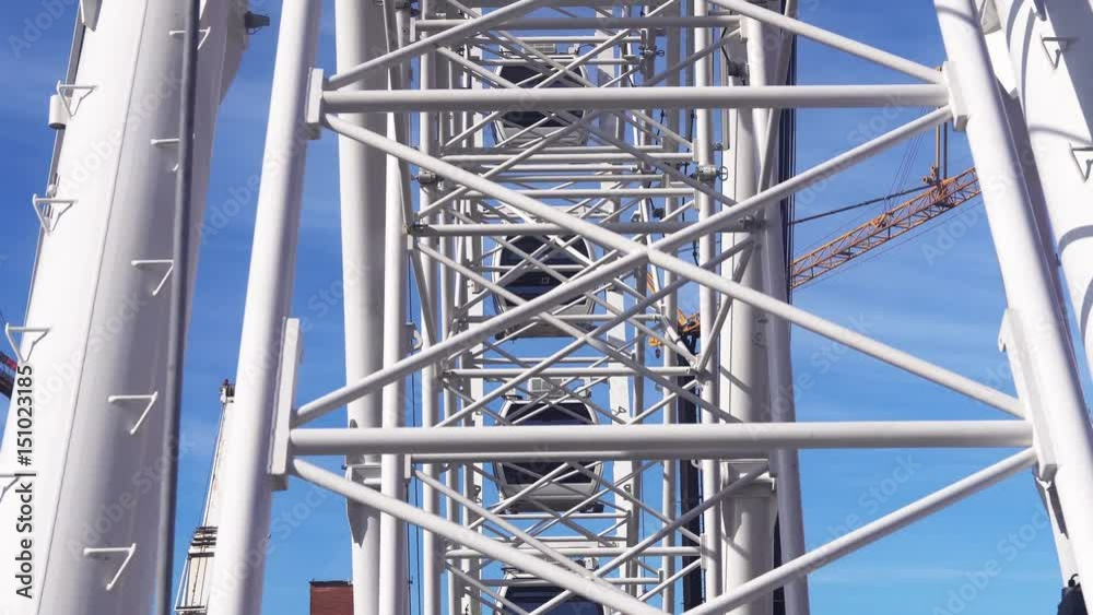 Sitting in Ferris wheel rotating on blue sky background. Sitting in Ferris wheel rotating on blue sky background.