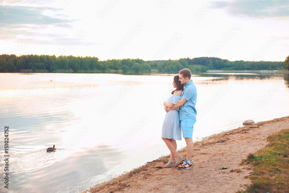 happy romantic couple in love and having fun at the lake outdoor in summer day, beauty of nature, harmony concept