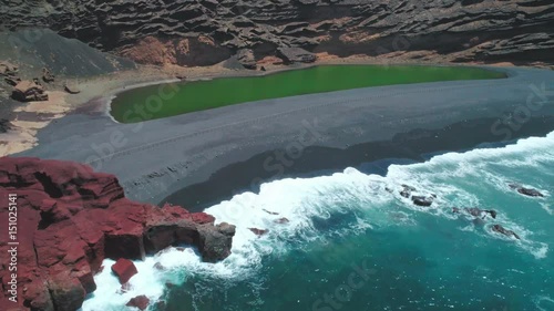 Cinematic Aerial Drone Reveal shot of Green Lake Mountain Sea and Volcanoes in Lanzarote