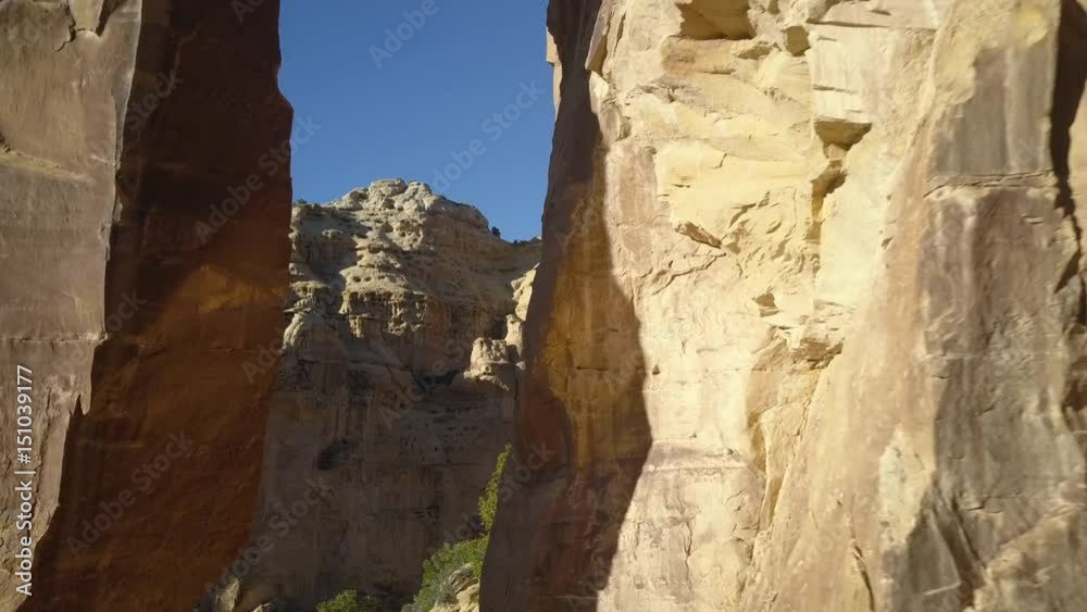 Aerial fly through natural Eagle Canyon Arch San Rafael Utah pull back. Overhead drone view. Geologic landscape. Dangerous wilderness desert environment.