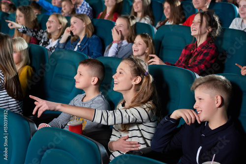 Shot of cheerful kids enjoying a movie at the cinema smiling pointing at the screen excitedly people childhood kids youth teenagers emotions expressive excitement entertainment leisure.