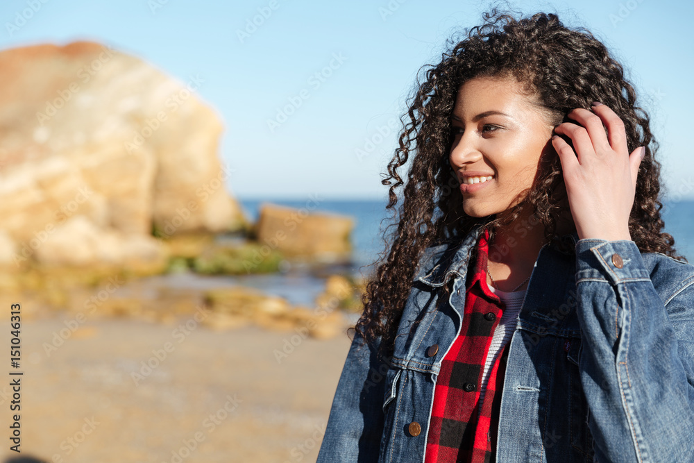 African young pretty lady walking outdoors at beach. African young pretty lady walking outdoors at beach.