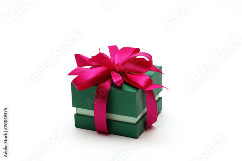 Green gift box with a red bow on a white background.