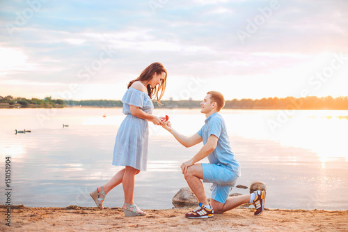 Marriage proposal on sunset . young man makes a proposal of betrothal to his girlfriend