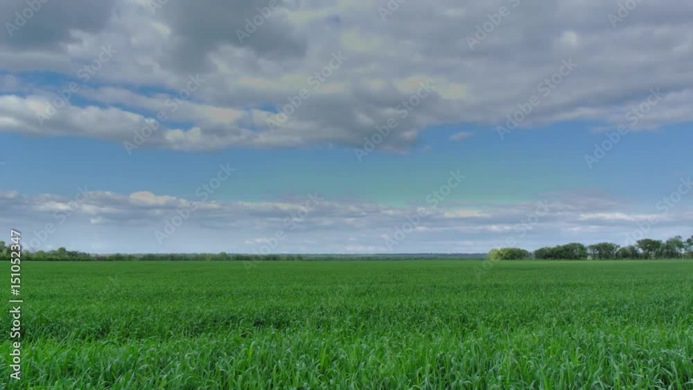 time lapse moving clouds over the green field time lapse moving clouds over the green field