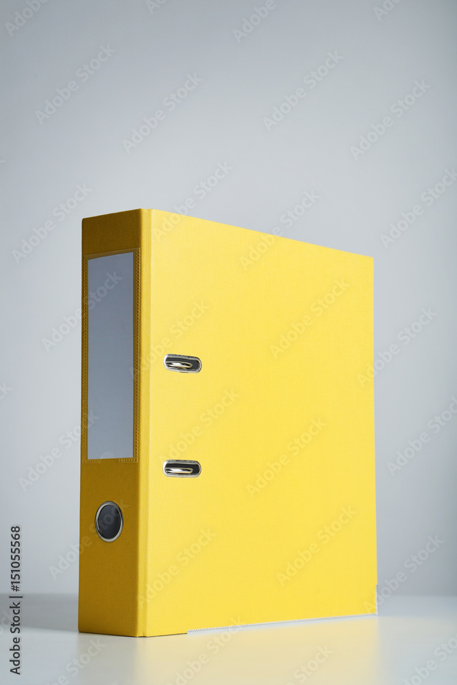 Yellow office folder on grey background Yellow office folder on grey background