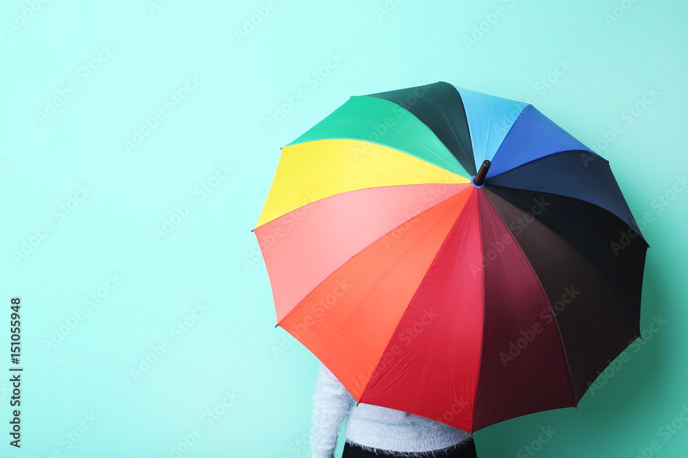 Colorful opened umbrella on green background