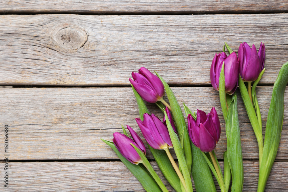 Bouquet of tulips on a grey wooden table