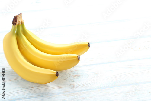 Sweet bananas on white wooden table