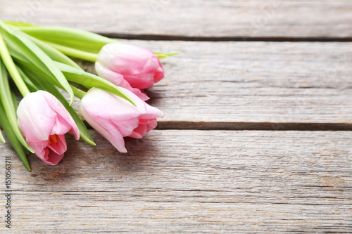 Bouquet of tulips on a grey wooden table