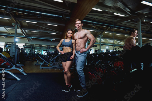 A beautiful sports body couple in the gym.