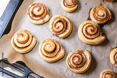 cinnamon buns on baking sheet on  oven pan