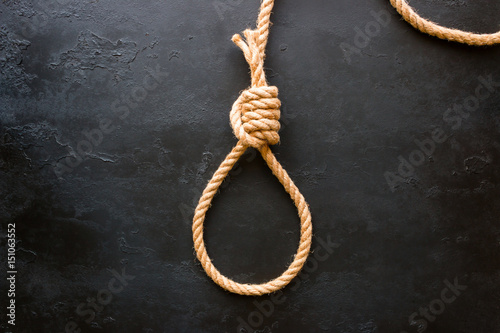 running knot of rope on a black background. Concept stop suicide