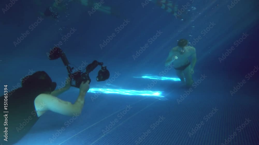 Underwater photography. A male model is posing underwater. A young handsome man is running along the bottom. Behined the scenes. Making of. Underwater photography. A male model is posing underwater. A young handsome man is running along the bottom. Behined the scenes. Making of.