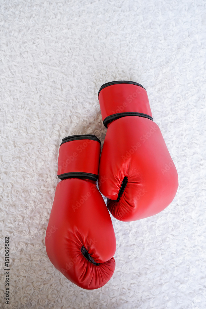 Red boxing glove on white fur textured background