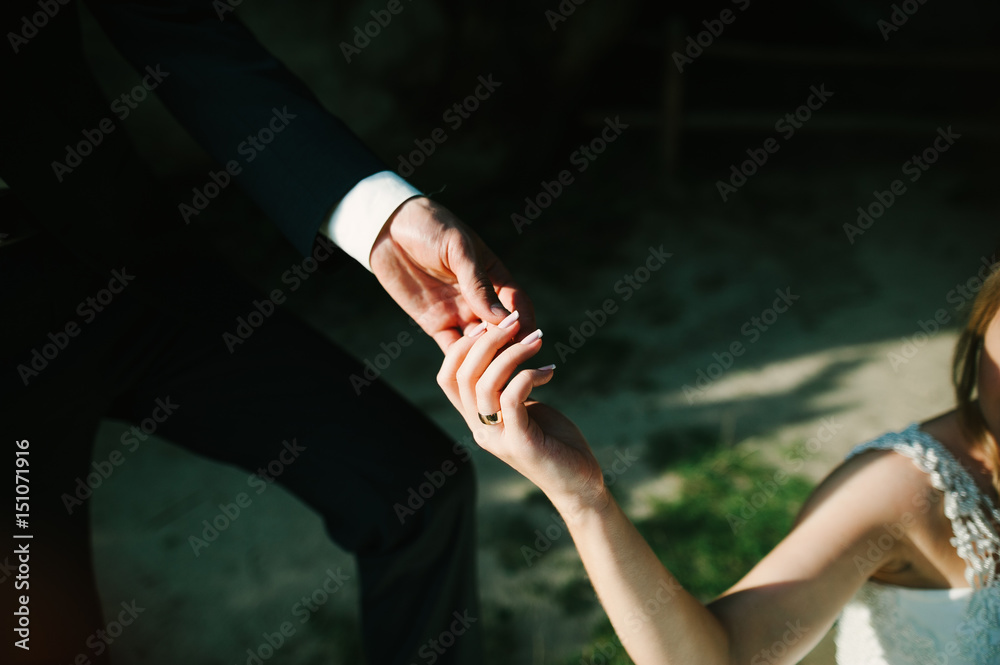 hand of a young couple at the wedding