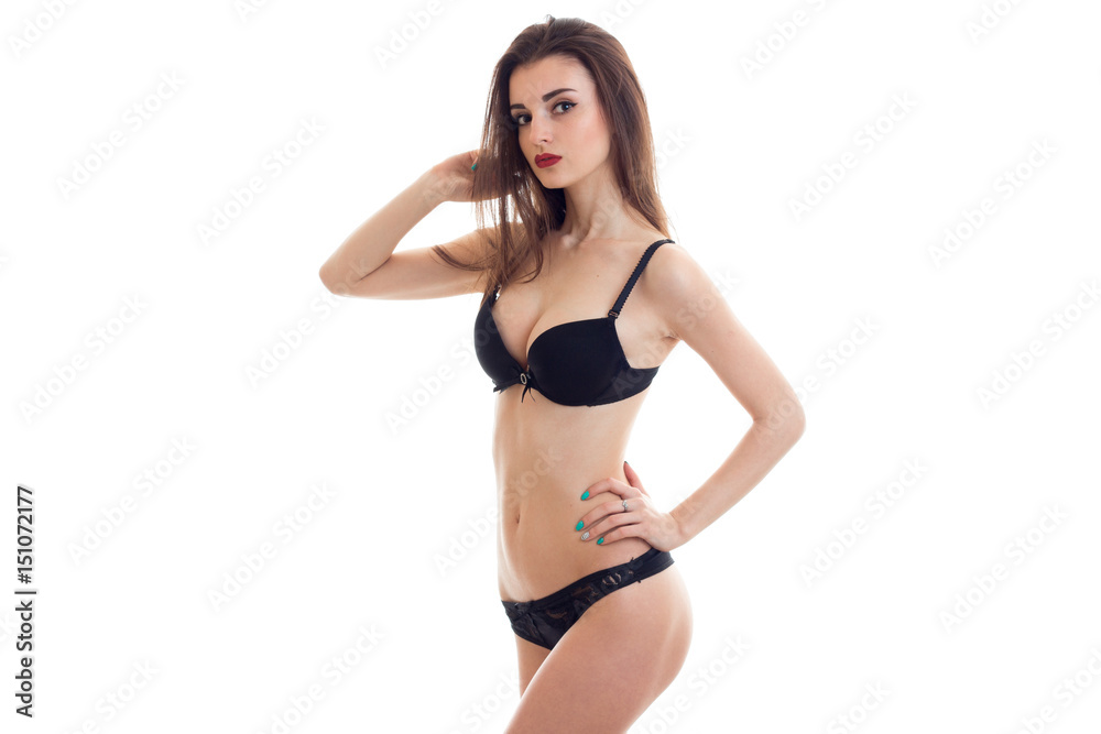 young sexy girl in black lingerie with beautiful breasts keeps her hand on the side and posing for the camera young sexy girl in black lingerie with beautiful breasts keeps her hand on the side and posing for the camera